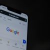 google search console 2024 in mobile with hand holding it just about to search for a shopify store